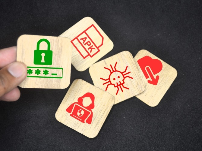 Smartphone on top of laptop keyboard showing the Android logo