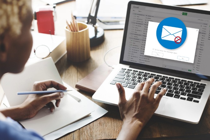 A man receives a clone phishing alert on his laptop.