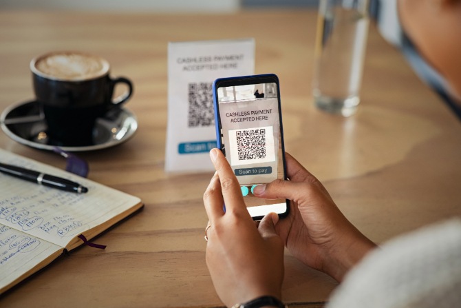 A woman scanning a QR code