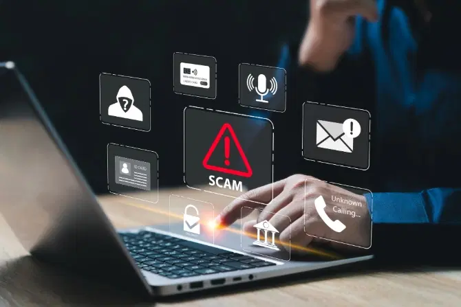 A person using a laptop with digital icons in the foreground relating to identity theft, such as a padlock and a warning sign