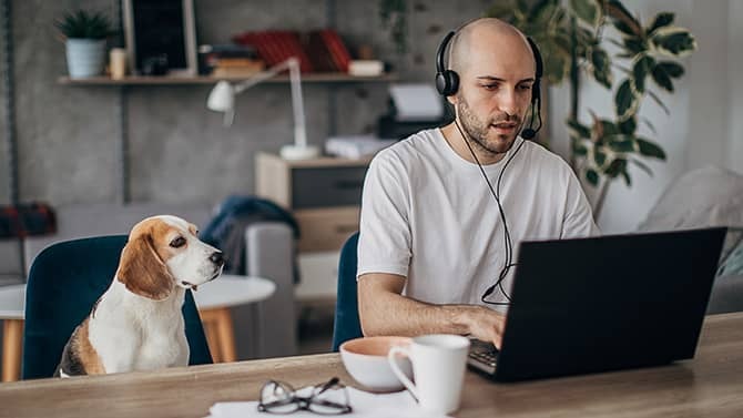 A guy in front of a computer on a video call