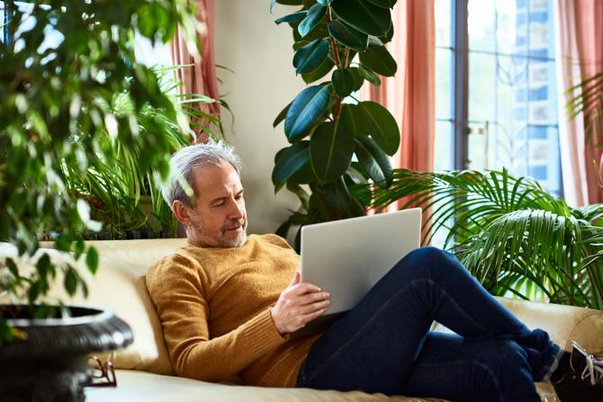 A man using a laptop attempts to troubleshoot VPN connection issues