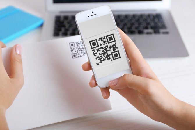 A woman scanning a QR code with her mobile phone