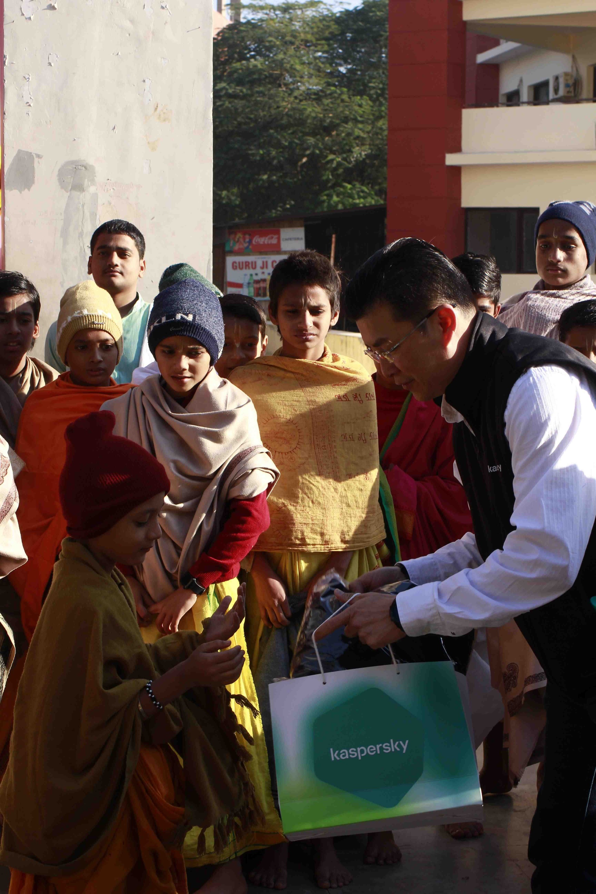 APAC Managing Director, Adrian Hia handing a warm jacket to one of the students