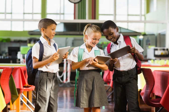 Children looking at a tablet. Parental controls can help to ensure kids are not exposed to inappropriate online content