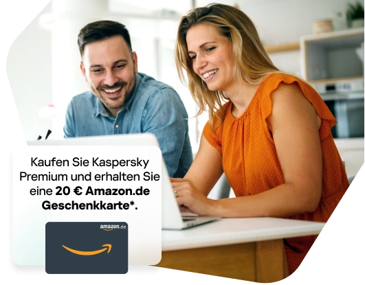 Happy couple smiling while browsing on a laptop
