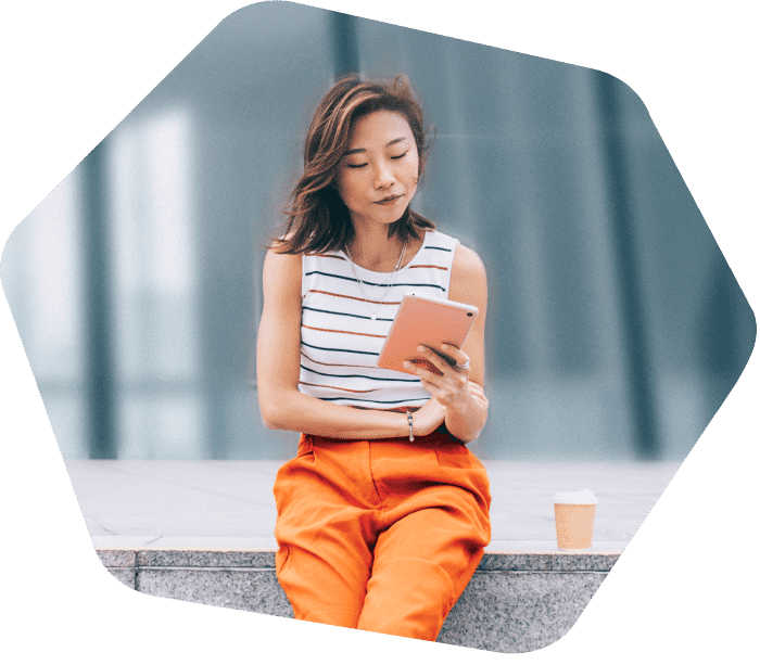 Lady sitting on the steps outside working on her laptop