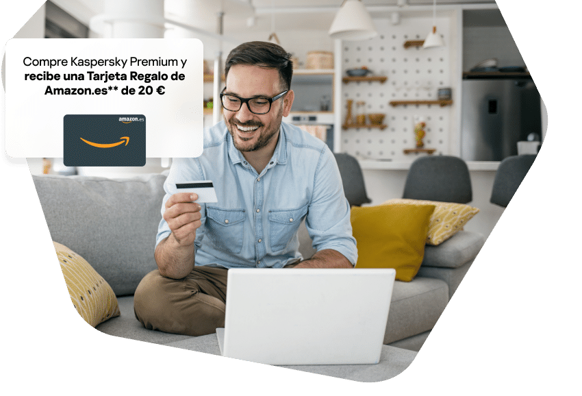 Man at home working using his phone and laptop