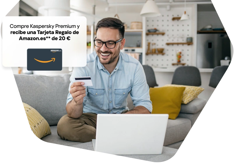 Man at home working using his phone and laptop