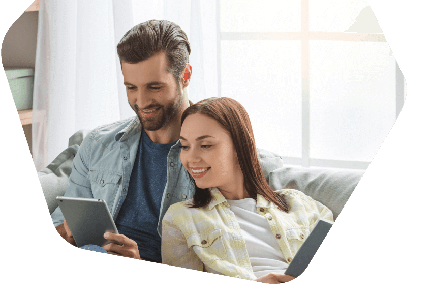 Young couple using their tablets at home