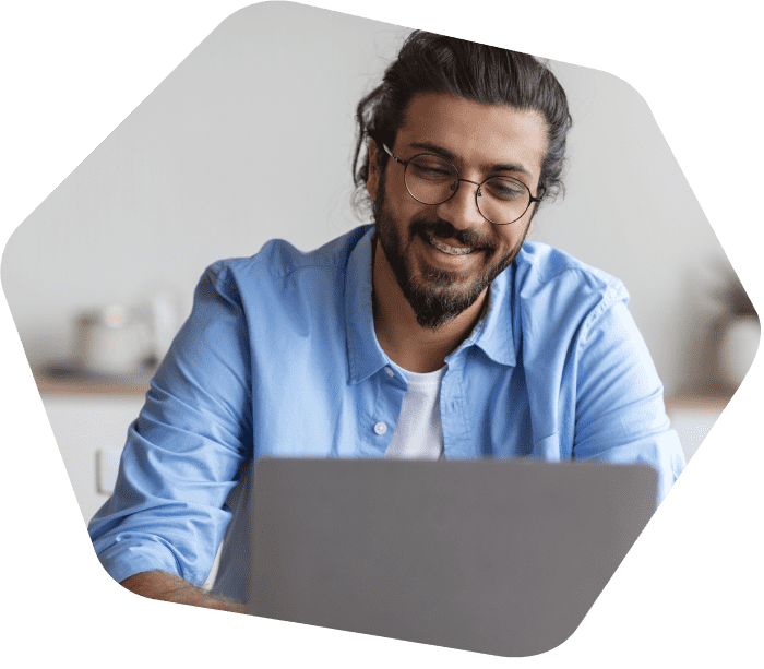 Man smiling on a call on his laptop 