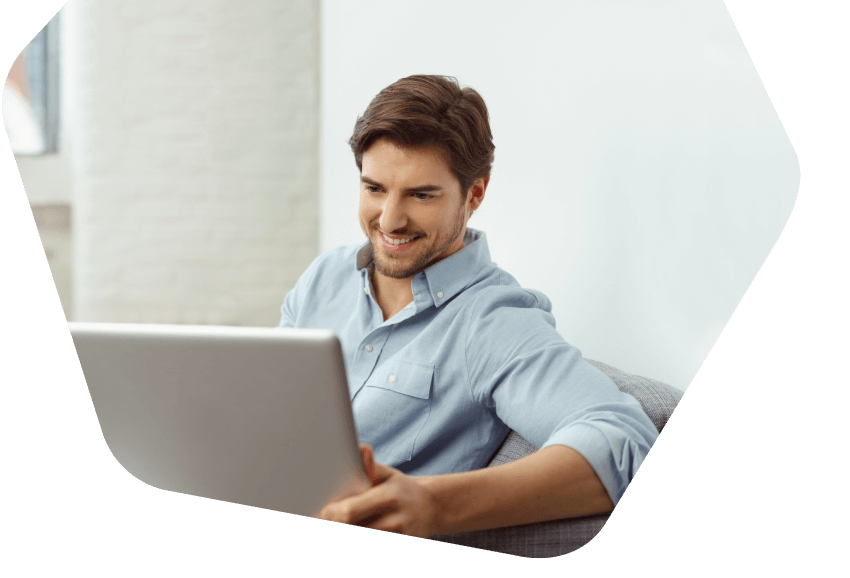 man happily looking at laptop