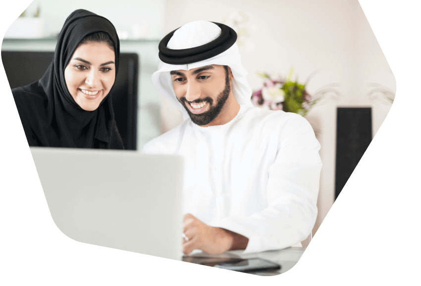 Couple smiling using computer